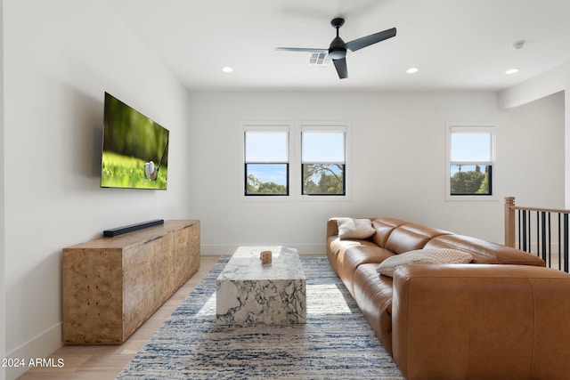 living room with ceiling fan and light hardwood / wood-style flooring