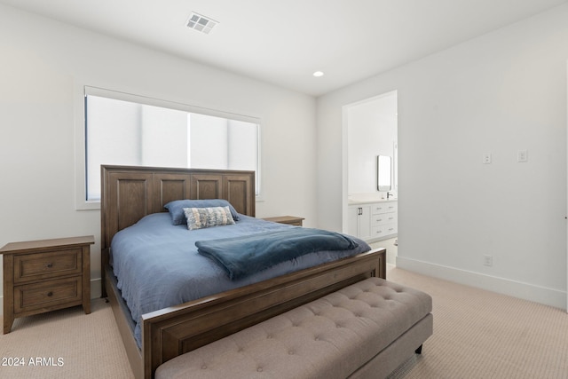 carpeted bedroom featuring connected bathroom and multiple windows