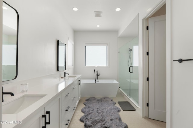 bathroom featuring tile patterned floors, vanity, and independent shower and bath