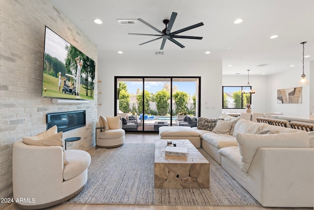 living room featuring ceiling fan and hardwood / wood-style floors