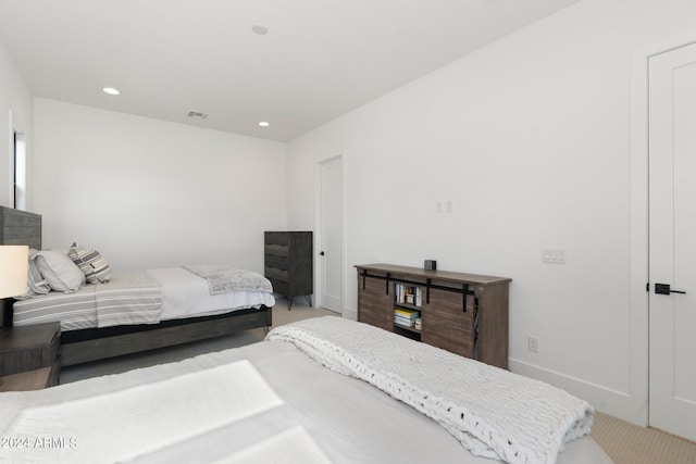 bedroom featuring light colored carpet