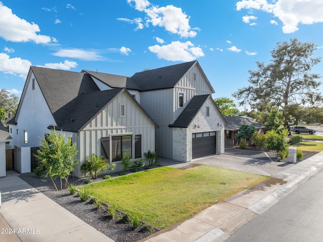 view of front of property featuring a front lawn and a garage