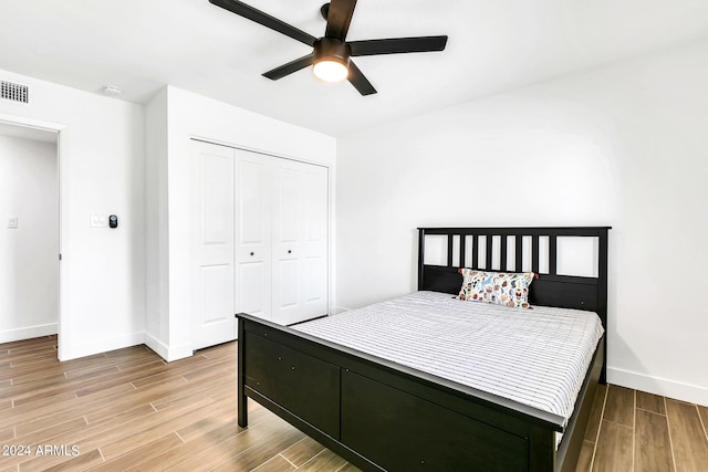 bedroom with ceiling fan and a closet