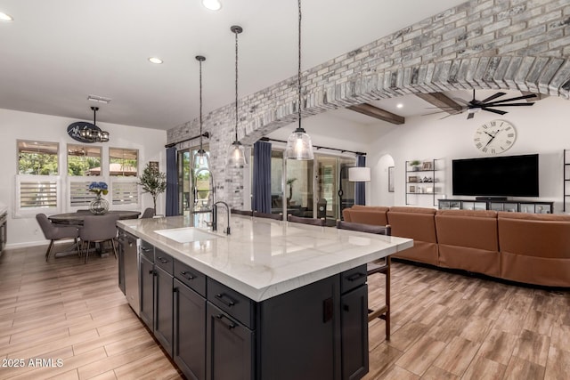3990 E Iris Dr, Chandler, AZ 85286 - kitchen featuring a sink, recessed lighting, light wood-type flooring, a ceiling fan, and a breakfast bar area