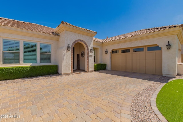 3990 E Iris Dr, Chandler, AZ 85286 - mediterranean / spanish house with an attached garage, stucco siding, decorative driveway, and a tile roof