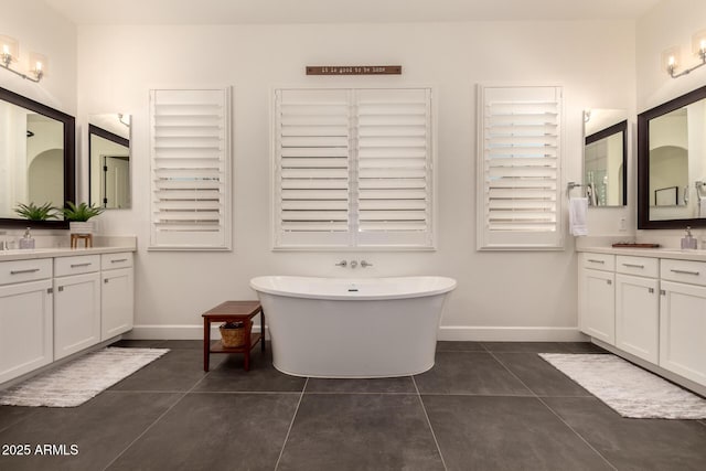 3990 E Iris Dr, Chandler, AZ 85286 - bathroom featuring two vanities, baseboards, a soaking tub, and tile patterned flooring