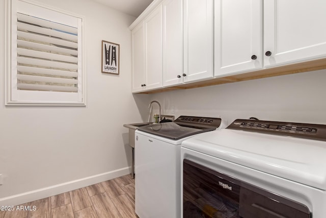 3990 E Iris Dr, Chandler, AZ 85286 - laundry room with washing machine and clothes dryer, cabinet space, baseboards, and light wood-style floors