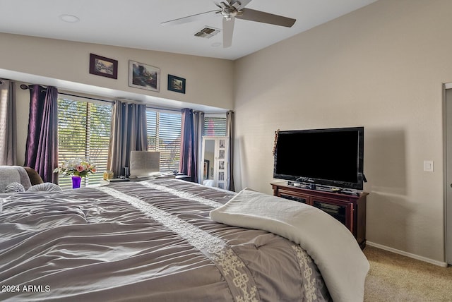 carpeted bedroom with ceiling fan and vaulted ceiling