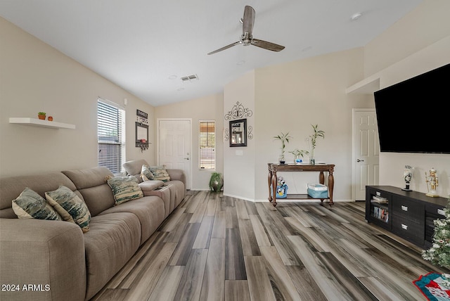 living room with hardwood / wood-style floors, vaulted ceiling, and ceiling fan