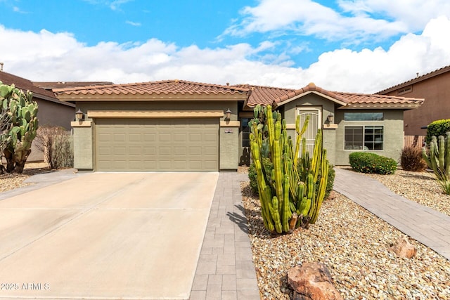 mediterranean / spanish-style home with stucco siding, concrete driveway, an attached garage, and a tile roof