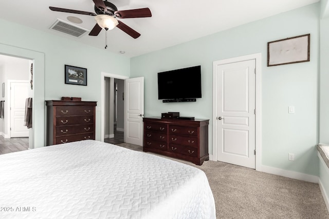 bedroom with visible vents, a ceiling fan, ensuite bath, carpet flooring, and baseboards