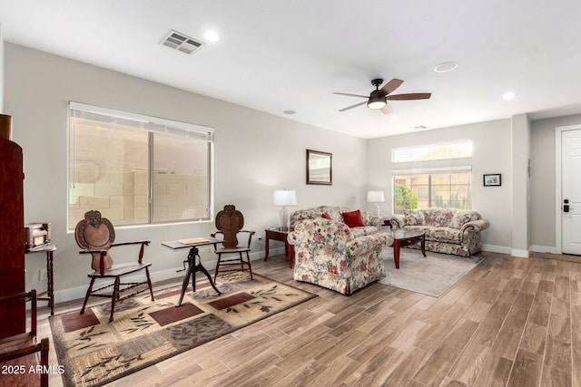 living room featuring visible vents, baseboards, ceiling fan, recessed lighting, and wood finished floors