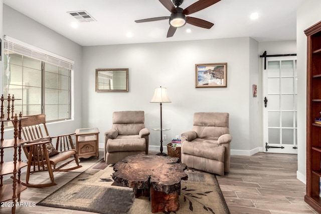 sitting room featuring wood finished floors, a ceiling fan, visible vents, baseboards, and recessed lighting