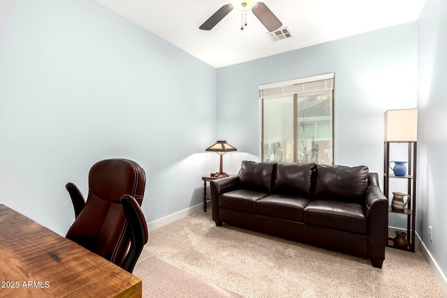 living area featuring visible vents, light colored carpet, baseboards, and a ceiling fan