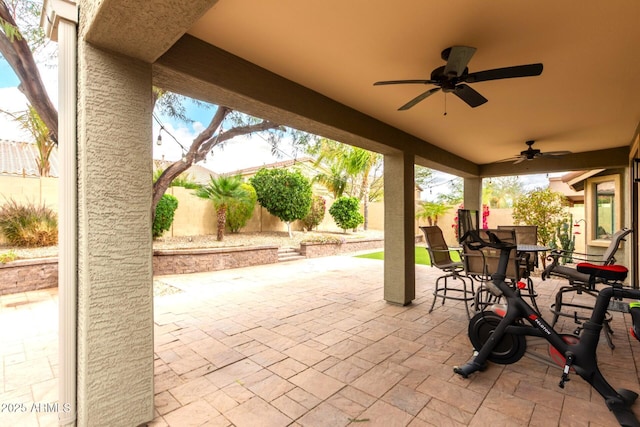 view of patio / terrace with outdoor dining area, a fenced backyard, and a ceiling fan