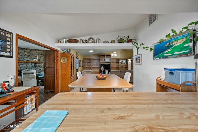 dining area with vaulted ceiling and ceiling fan