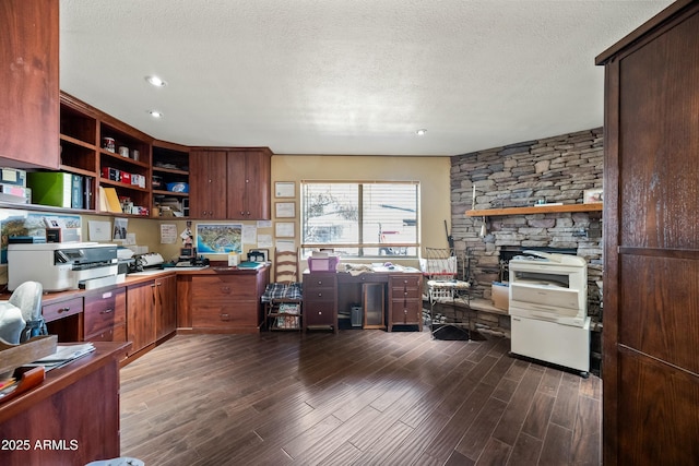 home office with dark hardwood / wood-style flooring and a textured ceiling