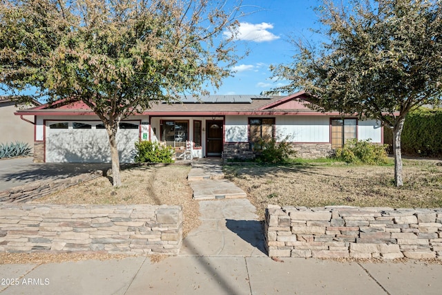 single story home featuring a garage and solar panels