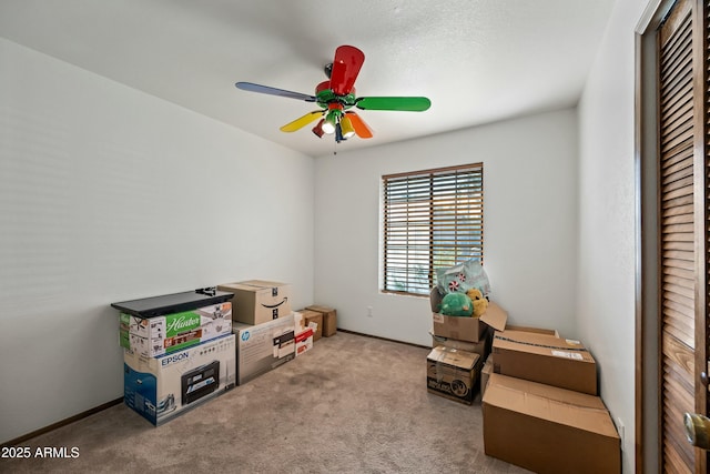 game room with carpet flooring and ceiling fan