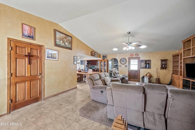 tiled living room featuring ceiling fan and lofted ceiling