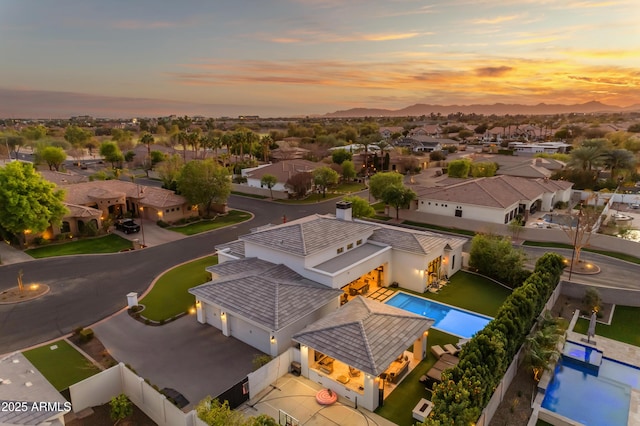 aerial view at dusk featuring a residential view