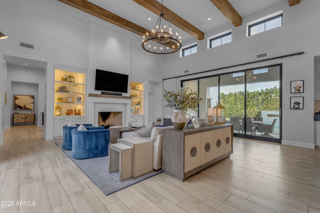 living room with light wood-style floors, visible vents, a fireplace, and a towering ceiling