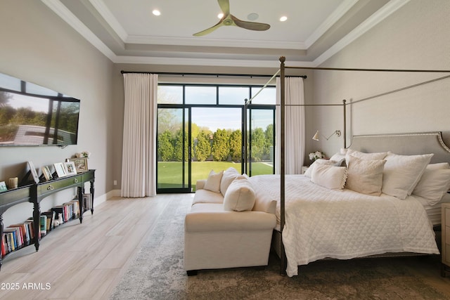 bedroom with access to outside, a raised ceiling, crown molding, and wood finished floors