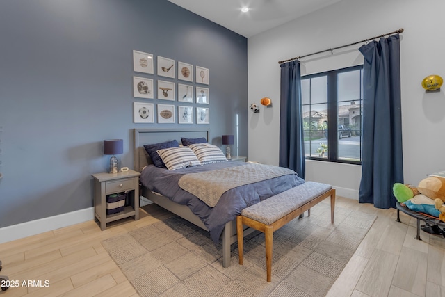 bedroom with light wood-style flooring and baseboards