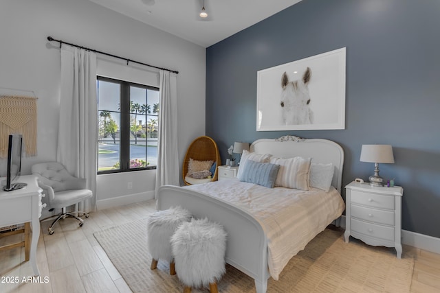 bedroom featuring light wood-style floors and baseboards