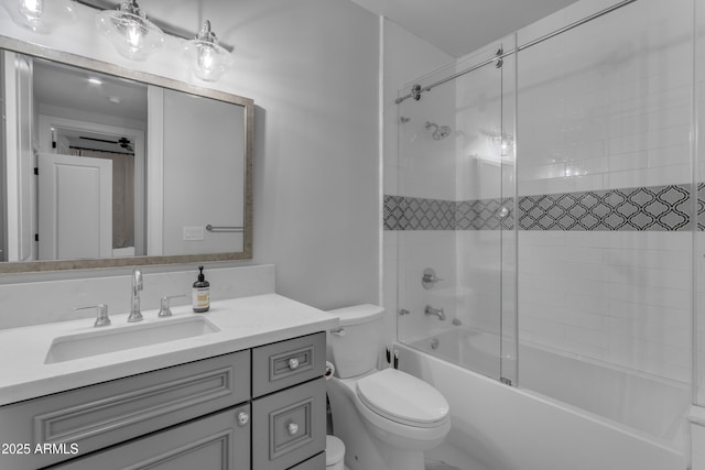 full bath with combined bath / shower with glass door, vanity, and toilet