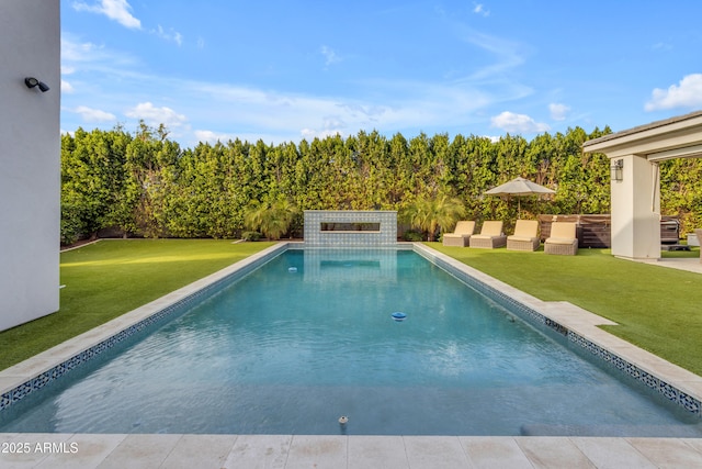 outdoor pool featuring a patio area, a fenced backyard, and a lawn