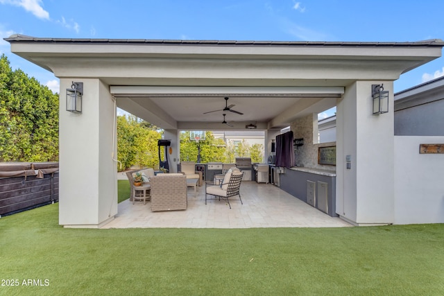 view of patio / terrace featuring exterior kitchen and a ceiling fan