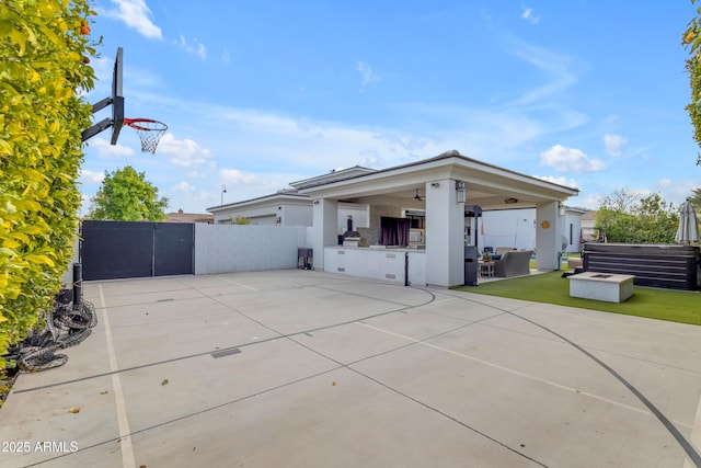 rear view of house with a patio, fence, and a gate