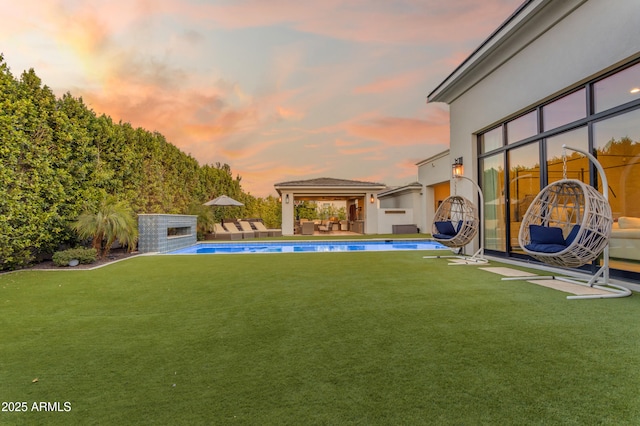 view of yard with an outdoor pool, a gazebo, and a patio