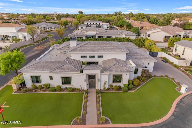 birds eye view of property with a residential view