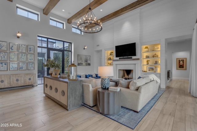 living area featuring wood tiled floor, a fireplace, a high ceiling, and beam ceiling