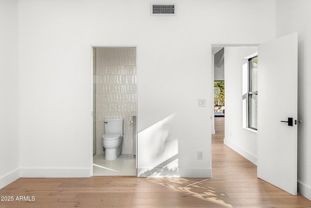 bathroom featuring hardwood / wood-style flooring and toilet