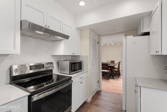 kitchen featuring wood finished floors, stainless steel appliances, light countertops, under cabinet range hood, and white cabinetry