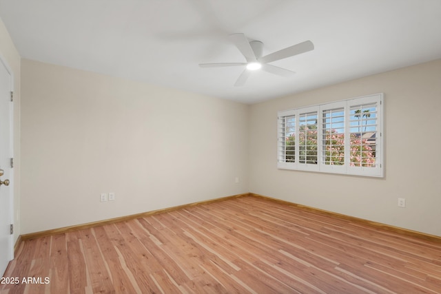 spare room with light wood-style flooring, baseboards, and ceiling fan