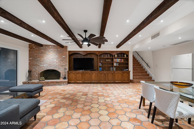 living room featuring a fireplace, beam ceiling, and ceiling fan