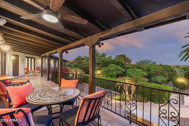 deck at dusk featuring french doors and ceiling fan