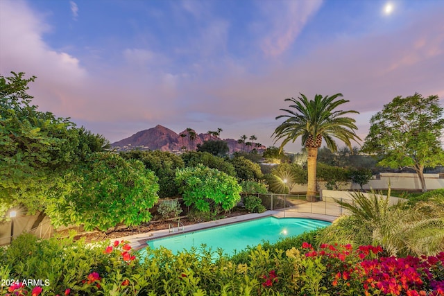 pool at dusk with a mountain view