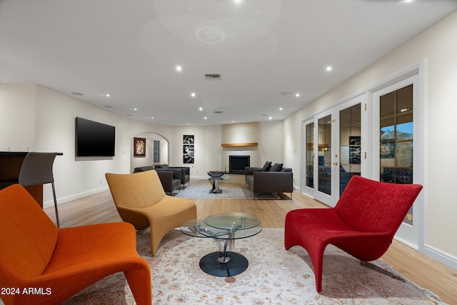 living room featuring light wood-type flooring and french doors