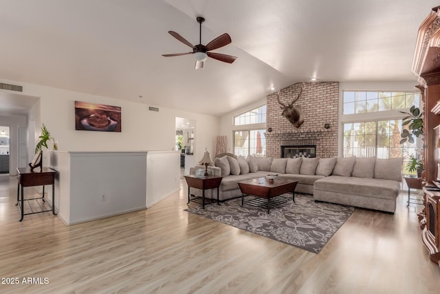 5237 N 106th Ave, Glendale, AZ 85307 - living room featuring ceiling fan, a brick fireplace, vaulted ceiling, and wood finished floors