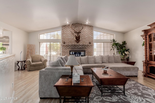 5237 N 106th Ave, Glendale, AZ 85307 - living area featuring vaulted ceiling, plenty of natural light, wood finished floors, and a brick fireplace
