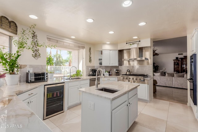 5237 N 106th Ave, Glendale, AZ 85307 - kitchen featuring beverage cooler, white cabinets, decorative backsplash, light stone countertops, and recessed lighting