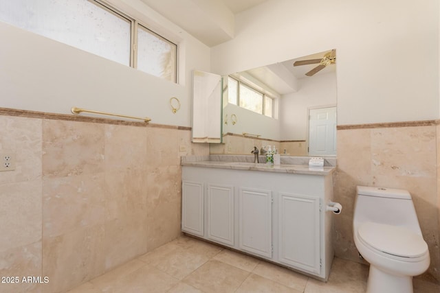 5237 N 106th Ave, Glendale, AZ 85307 - bathroom featuring tile walls, tile patterned flooring, a ceiling fan, vanity, and wainscoting