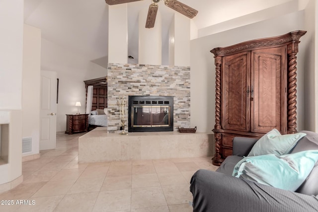 5237 N 106th Ave, Glendale, AZ 85307 - living room featuring high vaulted ceiling, light tile patterned floors, a tiled fireplace, and a ceiling fan