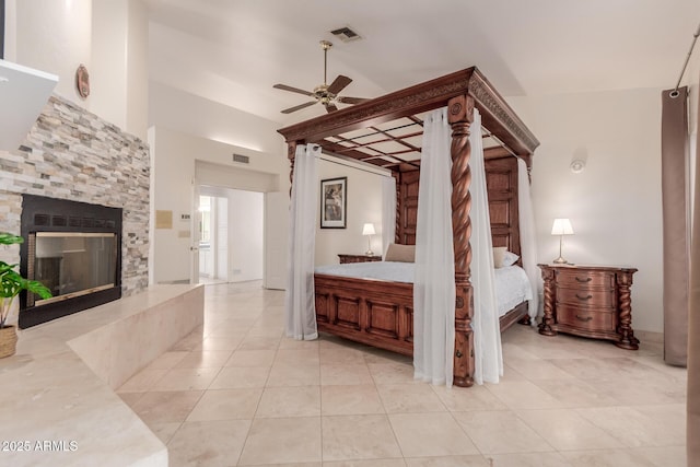 5237 N 106th Ave, Glendale, AZ 85307 - unfurnished bedroom featuring light tile patterned flooring, a glass covered fireplace, lofted ceiling, and ceiling fan
