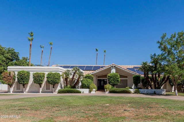 5237 N 106th Ave, Glendale, AZ 85307 - view of front of property featuring solar panels, a front yard, and stucco siding